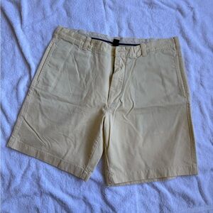 J Crew.  Classic “hard khaki” shorts in pale yellow.   38 waist.